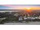 Overhead shot of beachfront home with coastline, surrounding neighborhood and ocean with sunset at 4911 S Atlantic Ave, Ponce Inlet, FL 32127