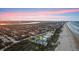 Aerial view of a coastal community showcasing homes with private beach access, lush trees, and scenic waterfront living at 4911 S Atlantic Ave, Ponce Inlet, FL 32127