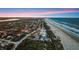 Wide aerial view of a beachfront neighborhood offering ocean views, mature trees, and scenic waterfront living at 4911 S Atlantic Ave, Ponce Inlet, FL 32127