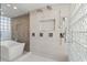 Modern bathroom with glass block window, soaking tub, dual shower heads, and sleek fixtures at 4911 S Atlantic Ave, Ponce Inlet, FL 32127