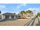 Circular driveway showcasing a large home, three-car garage, palm trees, and landscaped flowerbeds at 4911 S Atlantic Ave, Ponce Inlet, FL 32127