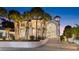 A striking view of a white home with a circular driveway, fountain and steps leading to a grand entrance at 4911 S Atlantic Ave, Ponce Inlet, FL 32127