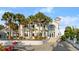 Elegant home featuring a paver driveway, manicured landscaping, and unique architectural design with steps to the front door at 4911 S Atlantic Ave, Ponce Inlet, FL 32127