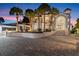 Stately house with a circular driveway and lush landscaping leading to a grand entrance at 4911 S Atlantic Ave, Ponce Inlet, FL 32127
