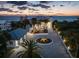 Stunning oceanfront home featuring a circular driveway, meticulous landscaping, and beautiful sunset views at 4911 S Atlantic Ave, Ponce Inlet, FL 32127