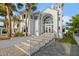 Stately home featuring a grand entrance, impressive architecture, and lush landscaping at 4911 S Atlantic Ave, Ponce Inlet, FL 32127