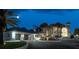 Nighttime view of a grand home with a fountain, three-car garage, and illuminated driveway, creating a luxurious ambiance at 4911 S Atlantic Ave, Ponce Inlet, FL 32127