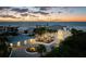 Panoramic shot of a beautiful two-story home with a three-car garage near a pristine beach at dusk at 4911 S Atlantic Ave, Ponce Inlet, FL 32127