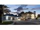 Gorgeous home featuring a circular driveway, a three-car garage, and mature landscaping at 4911 S Atlantic Ave, Ponce Inlet, FL 32127