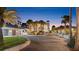 Elegant house with a three-car garage, circular driveway, and lush landscaping at twilight at 4911 S Atlantic Ave, Ponce Inlet, FL 32127