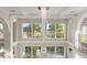 Bright and airy foyer featuring a stunning chandelier and a view of the outside landscaping at 4911 S Atlantic Ave, Ponce Inlet, FL 32127