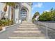 Elegant home showcasing a striking front entrance, complemented by palm trees at 4911 S Atlantic Ave, Ponce Inlet, FL 32127