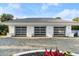Three-car garage with modern glass doors and tiled roof, adding curb appeal at 4911 S Atlantic Ave, Ponce Inlet, FL 32127