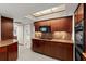 Modern kitchen featuring wooden cabinetry, granite countertops, and an electric cooktop at 4911 S Atlantic Ave, Ponce Inlet, FL 32127