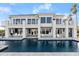 Exterior view of a house with large windows and a pool with lounge chairs at 4911 S Atlantic Ave, Ponce Inlet, FL 32127