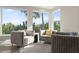 Relax in this cozy sitting area with palm tree views and comfortable seating at 4911 S Atlantic Ave, Ponce Inlet, FL 32127