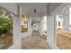 Covered walkway to home featuring stone paving and lush tropical landscaping at 4911 S Atlantic Ave, Ponce Inlet, FL 32127