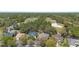 Beautiful aerial view of homes nestled near a lush golf course and green wooded area at 509 Victoria Hills Dr, Deland, FL 32724