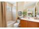 Bathroom with a shower-tub combo, tile backsplash, and single vanity at 509 Victoria Hills Dr, Deland, FL 32724