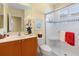 Bathroom features white tile shower with glass door, a white toilet and a wooden sink cabinet with a white countertop at 509 Victoria Hills Dr, Deland, FL 32724