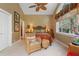 Cozy bedroom with a vaulted ceiling, a ceiling fan, and comfortable seating area at 509 Victoria Hills Dr, Deland, FL 32724