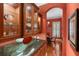 A butler pantry with granite countertops and glass-front cabinets leading to a dining room at 509 Victoria Hills Dr, Deland, FL 32724