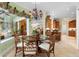 Comfortable dining area with seating for four, decorative chandelier, and lush green view at 509 Victoria Hills Dr, Deland, FL 32724