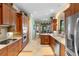 Bright kitchen with stainless steel appliances, granite countertops, and wood cabinets at 509 Victoria Hills Dr, Deland, FL 32724