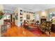 Bright living room with hardwood floors, fireplace, built-in shelving, and stylish decor at 509 Victoria Hills Dr, Deland, FL 32724