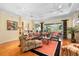 Spacious living room with hardwood floors, comfortable seating, and natural light from windows at 509 Victoria Hills Dr, Deland, FL 32724
