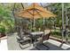 Covered outdoor dining area with a large table, seating for eight, and a view of the surrounding greenery at 509 Victoria Hills Dr, Deland, FL 32724