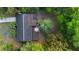 Aerial shot showcasing a backyard deck with outdoor seating surrounded by lush trees at 514 Land O Lakes Ct, Deland, FL 32724