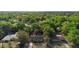 Aerial view of a home nestled among lush trees, showcasing its tranquil setting at 514 Land O Lakes Ct, Deland, FL 32724