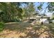 Expansive backyard featuring mature trees and a cozy hammock, perfect for relaxation at 514 Land O Lakes Ct, Deland, FL 32724