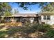 Backyard featuring a screened-in porch area and a grassy lawn at 514 Land O Lakes Ct, Deland, FL 32724