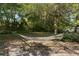 Relaxing hammock nestled in a spacious, shaded backyard surrounded by mature trees at 514 Land O Lakes Ct, Deland, FL 32724