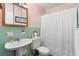 Cozy bathroom with pastel green tile, a mirrored medicine cabinet and shower with curtain at 514 Land O Lakes Ct, Deland, FL 32724