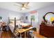 Bright bedroom features a ceiling fan, hardwood floors, and natural light from the large windows at 514 Land O Lakes Ct, Deland, FL 32724