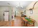 View of the dining area with hardwood floors leading to the kitchen and front door at 514 Land O Lakes Ct, Deland, FL 32724
