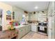 Charming kitchen featuring tile floors, white appliances, and ample cabinet storage at 514 Land O Lakes Ct, Deland, FL 32724