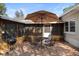 Brick patio with grill, table and chairs under umbrella perfect for outdoor dining at 514 Land O Lakes Ct, Deland, FL 32724