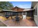 Brick patio with grill, table and chairs under umbrella perfect for outdoor dining at 514 Land O Lakes Ct, Deland, FL 32724