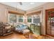 Cozy sun room featuring hardwood floors, comfortable seating, and natural light at 514 Land O Lakes Ct, Deland, FL 32724