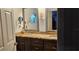 A well lit bathroom featuring neutral toned walls, unique architecture, granite countertop and ornate mirror at 520 Dixson St, Orange City, FL 32763