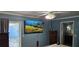 This bedroom offers a ceiling fan, mounted TV and sliding door to the outdoors at 520 Dixson St, Orange City, FL 32763