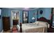 Charming bedroom with beautiful blue walls, a bed, and an adjoining bathroom for added convenience at 520 Dixson St, Orange City, FL 32763