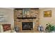 Brick fireplace with a decorative mantel, potted plants, and white leather sofa at 520 Dixson St, Orange City, FL 32763