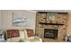 Comfortable seating area with fireplace, and neutral-toned leather sofa in a well-lit room at 520 Dixson St, Orange City, FL 32763