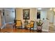 Hallway with hardwood floors leading to an open kitchen and bathroom, with floral decorations at 520 Dixson St, Orange City, FL 32763