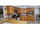 Kitchen features warm wood cabinets, a breakfast bar, and stainless steel oven range at 520 Dixson St, Orange City, FL 32763